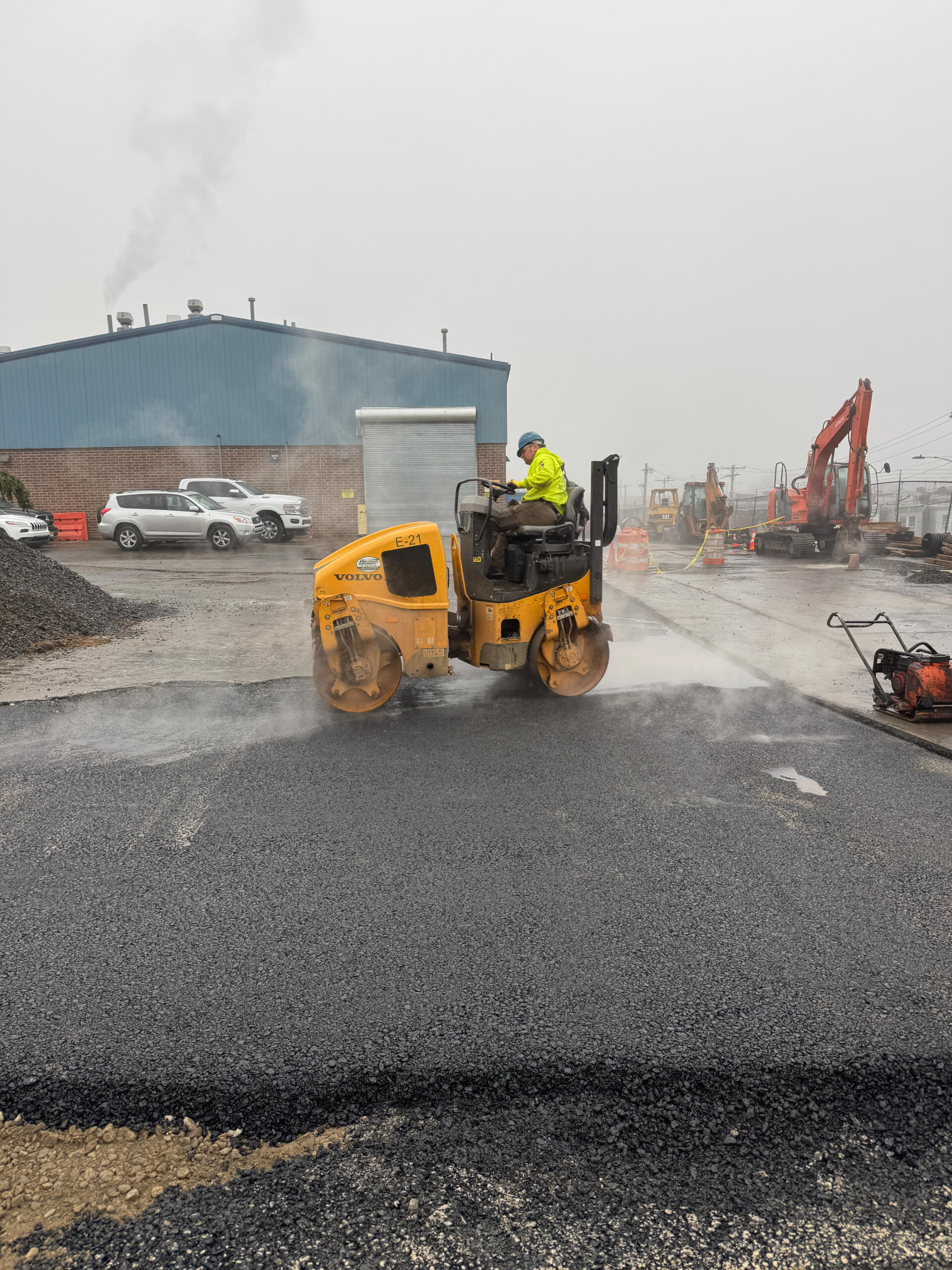Compacting freshly laid asphalt